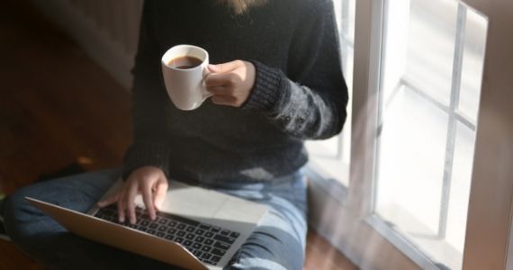 Student at computer with coffee